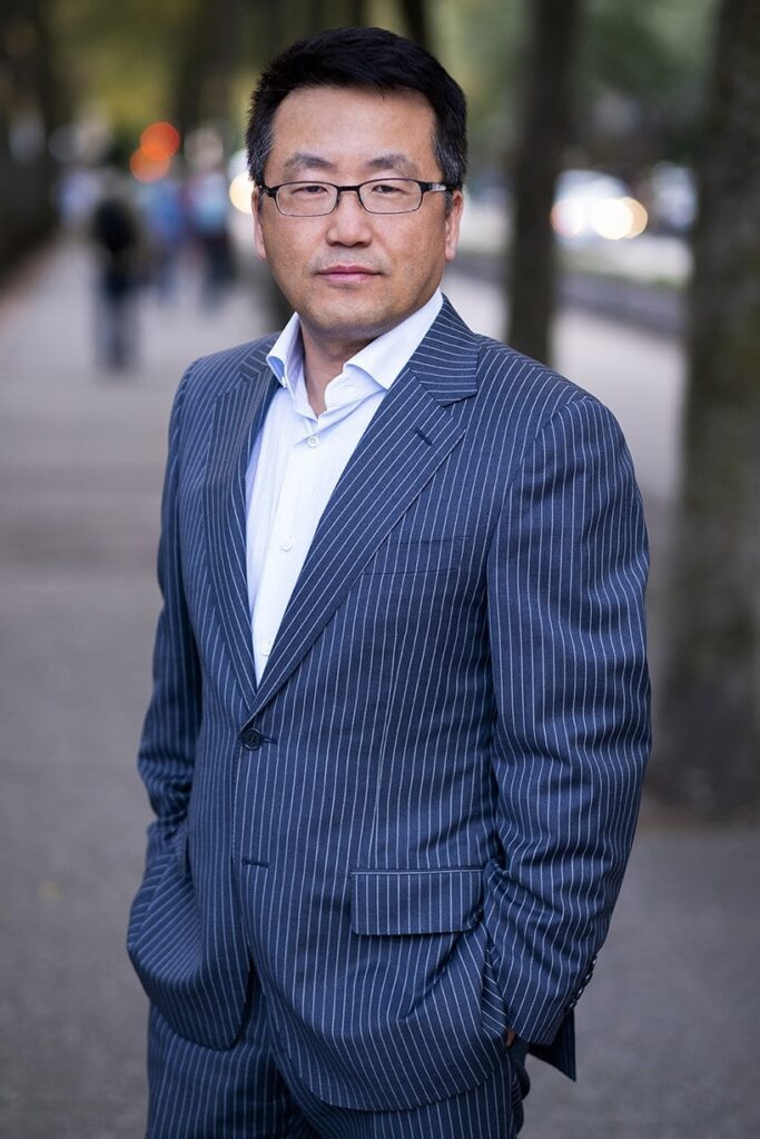 Tired professional forced to smile during a generic headshot session