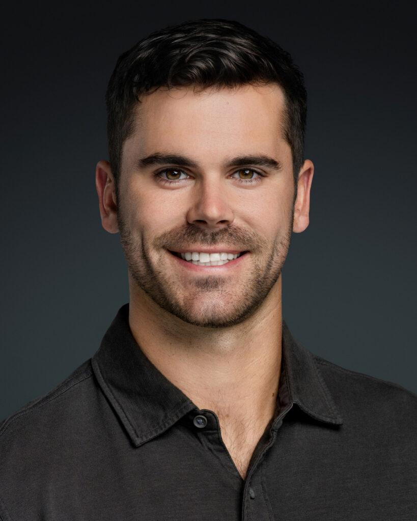 Modern headshot of a business professional with ocean backdrop, photographed by Art of Portraits, Newport Beach photographer for personal branding.