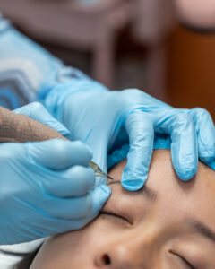 Ava applying microblading strokes at AVA Permanent Makeup & Spa in 