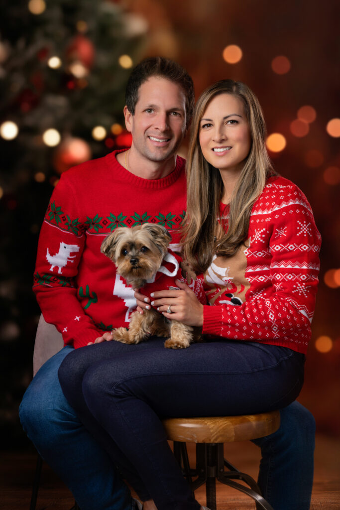 Family pet Christmas portrait—captured by Art of Portraits® with festive holiday decor and warm seasonal lighting.