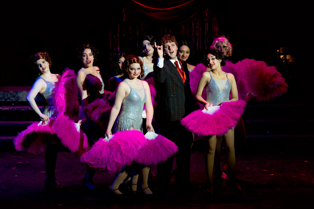 Chicago Musical Performance dancers with vibrant pink costumes by the Corona Del Mar High